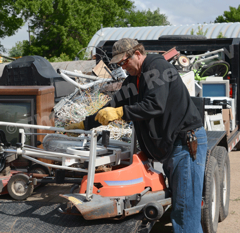 cleanup_9524 Jerry Finkrel loads up metal junk to a trailer to be hauled away. E-R photo
